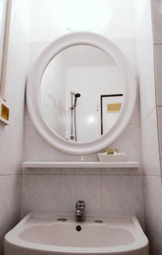 a bathroom with a sink and a mirror at Hotel Suisse in Sestri Levante