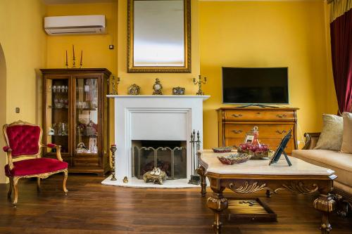 a living room with a couch and a fireplace at Palazzino Di Nionio in Karavadhos