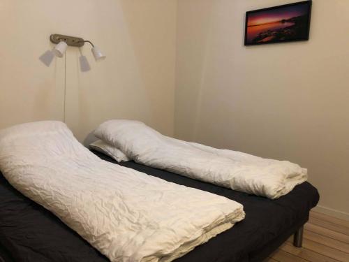 two white pillows sitting on a bed in a room at Kang Apartments in Nuuk