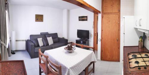 a living room with a table and a couch at EVA & TRAVEL - Cal Marcel Prades in Prades