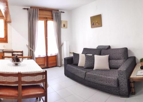 a living room with a couch and a table at EVA & TRAVEL - Cal Marcel Prades in Prades