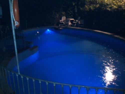 a large blue bath tub in a dark room at Hotel Kyrton in Forte dei Marmi