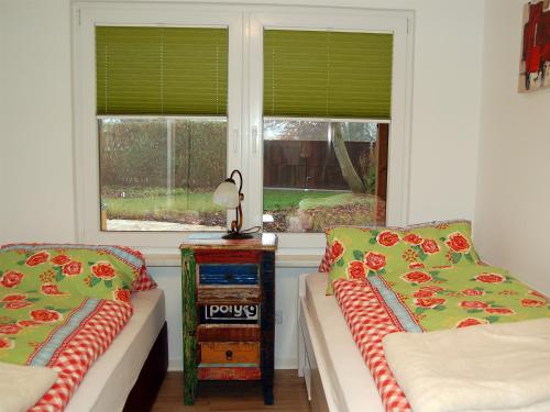 a living room with two beds and a window at Ferienhaus H.Winkler in Neukalen