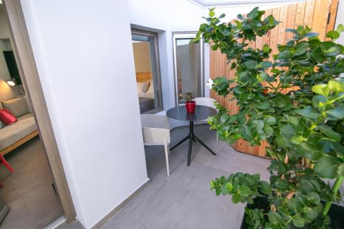 a room with a table and some plants at Marquise Suites - Adults Only in Fira