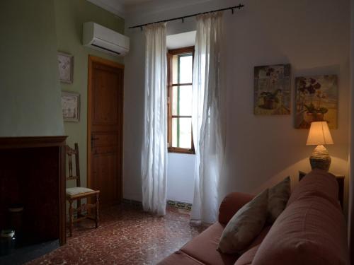 a living room with a couch and a window at Agroturismo Finca Son Sala in Campos
