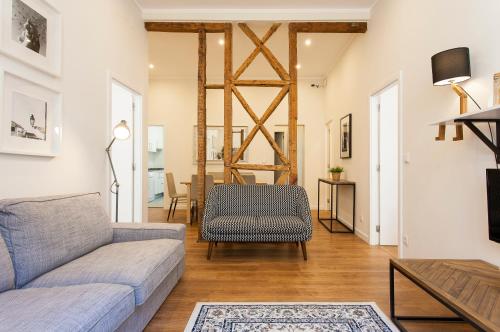 a living room with a couch and a table at Central Downtown by Central Hill Apartments in Lisbon