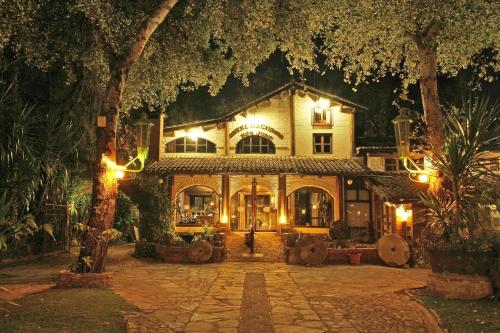 a large house with lights in front of it at Hotel Hacienda Don Juan in San Cristóbal de Las Casas