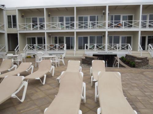 a row of chairs and tables in front of a building at Royal Atlantic Beach Resort in Montauk