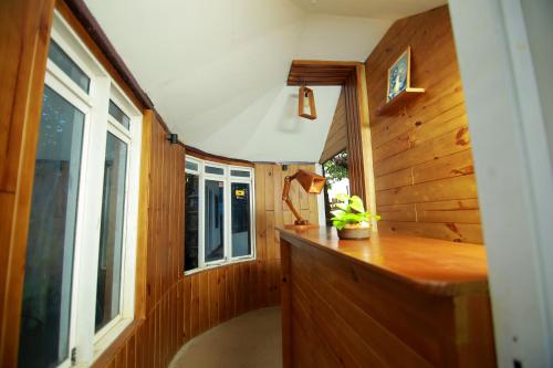 a small kitchen with a counter and a window at Shalom Beach Residency in Alleppey