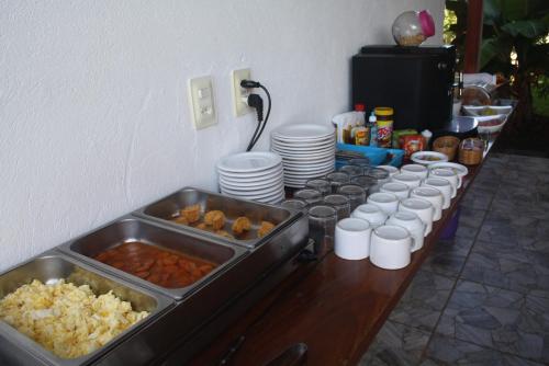 a table with a bunch of food on it at Villa Tropicale in Salvador
