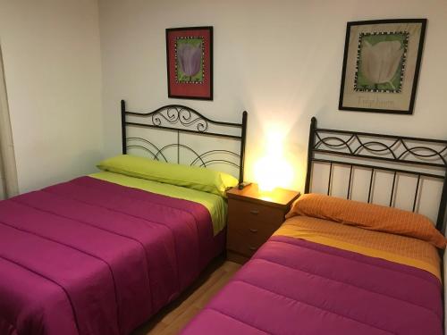 two beds sitting next to each other in a bedroom at Hostal Las Eras in Cubillos del Sil