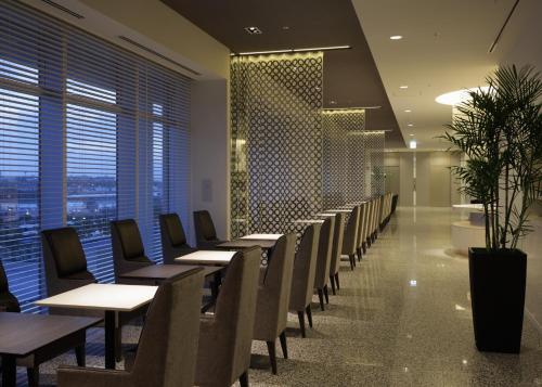 a row of tables and chairs in a restaurant at Naha Tokyu REI Hotel in Naha