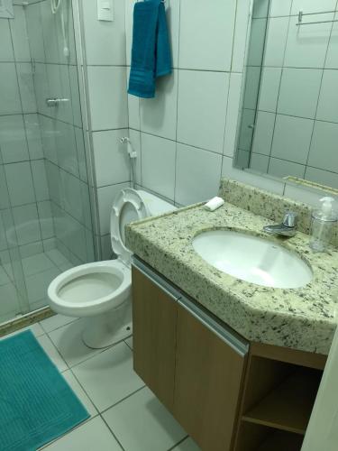 a bathroom with a sink and a toilet at Verano Praia Ponta Negra AP 1401 in Natal