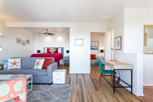 a living room with a couch and a bed at The Sea View Inn At The Beach in Manhattan Beach