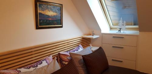 a living room with a couch and a painting on the wall at Yellow apartma Kranjska Gora in Kranjska Gora