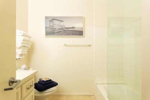 a bathroom with a shower and a toilet at The Sea View Inn At The Beach in Manhattan Beach