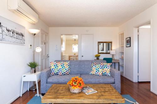 a living room with a couch and a table at The Sea View Inn At The Beach in Manhattan Beach