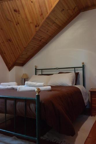 una camera con un grande letto e un soffitto in legno di Casas do Trabulo a Decermilo