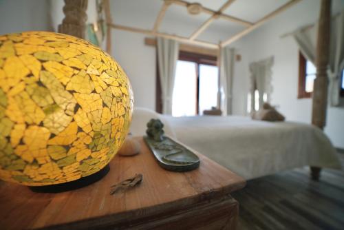a wooden table with a ball on top of a bed at Tindaya Nature Home Ocean View in Tindaya