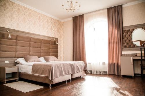 a bedroom with a large bed and a large window at Sky hotel in Isakovo