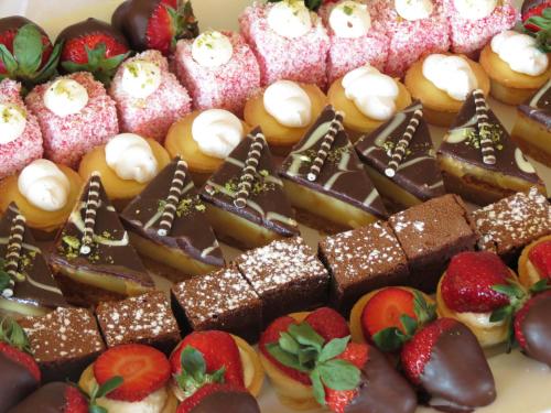 a bunch of different types of pastries and strawberries at Distinction Coachman Hotel, Palmerston North in Palmerston North