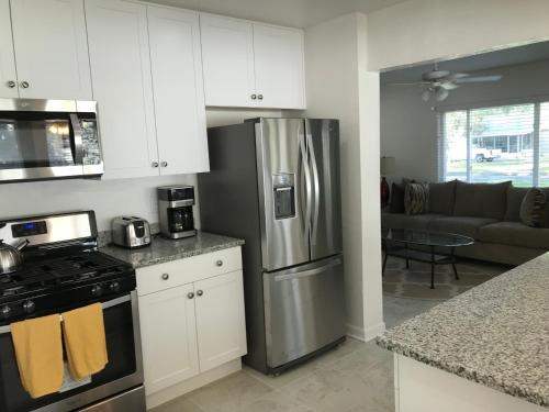 a kitchen with white cabinets and a stainless steel refrigerator at Pine Street in Clearwater