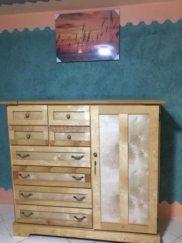 a wooden dresser with a tv on top of it at Becaville in Port Antonio