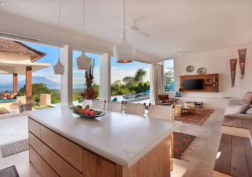 a kitchen and living room with a view of the ocean at 353 Degrees North in Nusa Lembongan