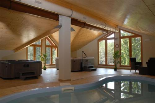 a large room with a swimming pool in a house at Hotel Sole Family Hotel in Predazzo
