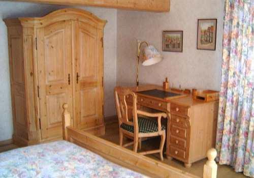 a room with a desk and a bed with a lamp at Landhotel Krone in Königsbach Stein