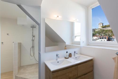 a bathroom with a sink and a mirror at Le Maransin in Lourdes