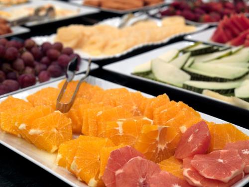 a white plate filled with different types of fruit at Hotel URH Palacio de Oriol in Santurce