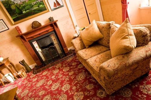 a living room filled with furniture and a fire place at Nethercliffe Hotel in Wick
