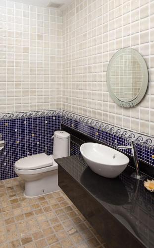 a bathroom with a sink and a toilet and a mirror at Sabai Private Pool Villa Khao Lak in Khao Lak