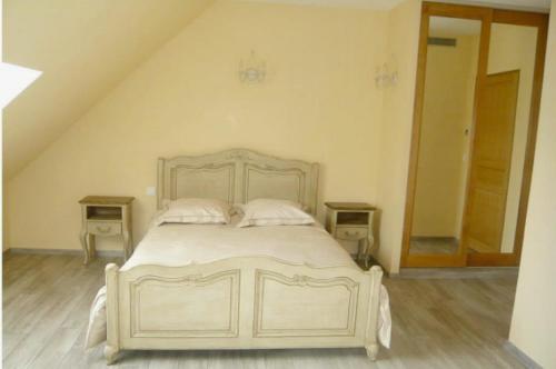 a bedroom with a white bed with two night stands at Domaine d'Auxonnettes Chambres d'Hôtes et Gîtes in Saint-Fargeau-Ponthierry