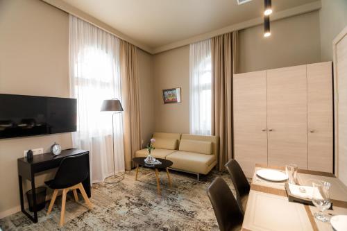 a living room with a couch and a table at Boutique Apart Hotel Adagio in Tbilisi City