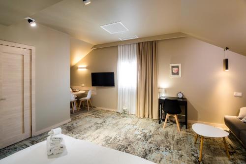 a living room with a couch and a table at Boutique Apart Hotel Adagio in Tbilisi City