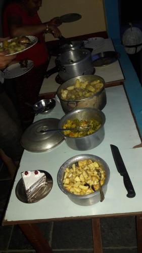 a table with bowls of food on top of it at Begnas Coffee House & Hotel in Deorāli