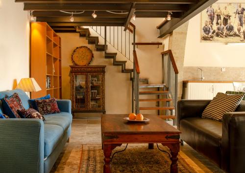 a living room with two couches and a table at Dolphin Guest House and Studios in Tochni