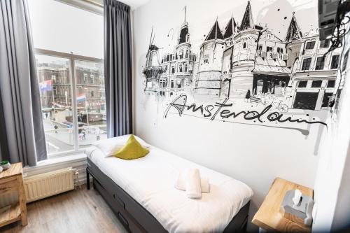 a bedroom with a bed with a drawing on the wall at Hotel Pagi in Amsterdam