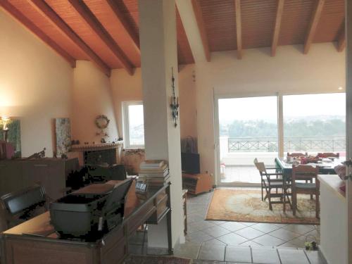 a living room with a view of a dining room at Adams Studio in Oropos in Oropos