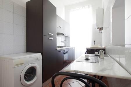 a kitchen with a washing machine in a kitchen at Roma Ostia 100 mt sea in Lido di Ostia