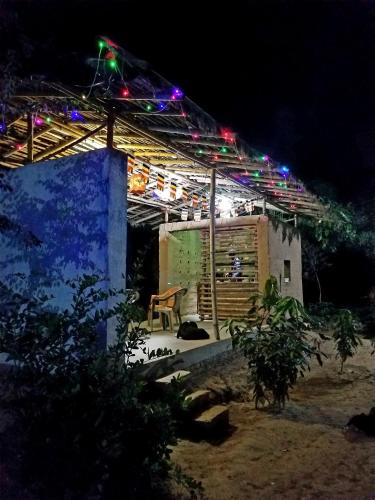 a lit up house with lights on it at night at Senamura Yoga Ashram Guesthouse in Bodh Gaya
