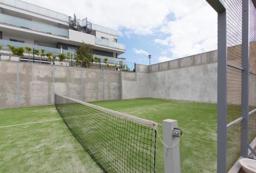 a tennis court with a net on top of a building at Surfer's Beach Apartment in La Tejita