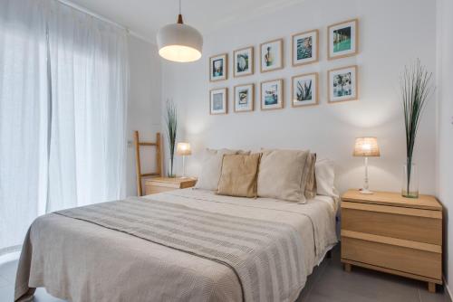 a bedroom with a large bed and two night stands at Surfer's Beach Apartment in La Tejita