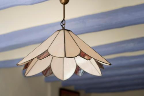a glass light fixture hanging from a ceiling at El 3 del Holandés in Balaguer