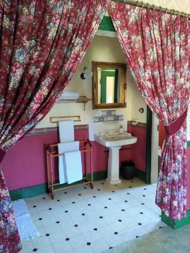 a bathroom with a sink and a mirror at A Pilgrims Rest in Graskop