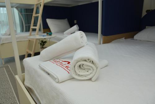a room with two beds with towels on them at Nar Palace in Istanbul