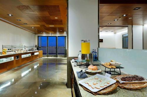a kitchen with a counter with some food on it at Eurostars Gran Valencia in Valencia