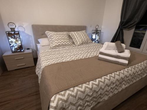 a bedroom with a large bed and a night stand at Rigoletto Massena in Nice